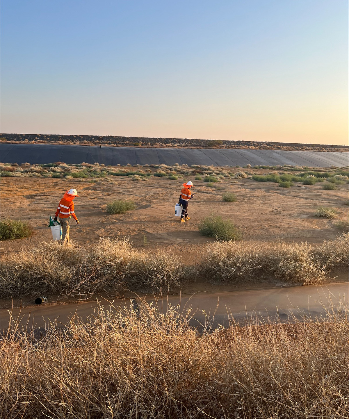 MIWATCH team on field work walking through dry tailings