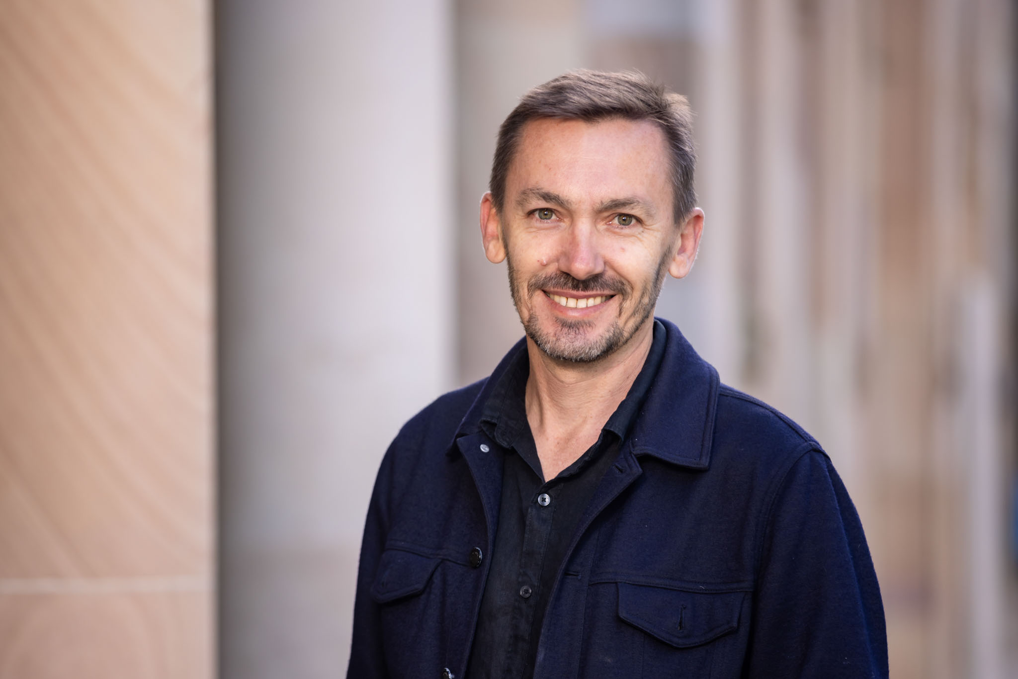 Daniel Franks in the UQ Great Court, sandstone background