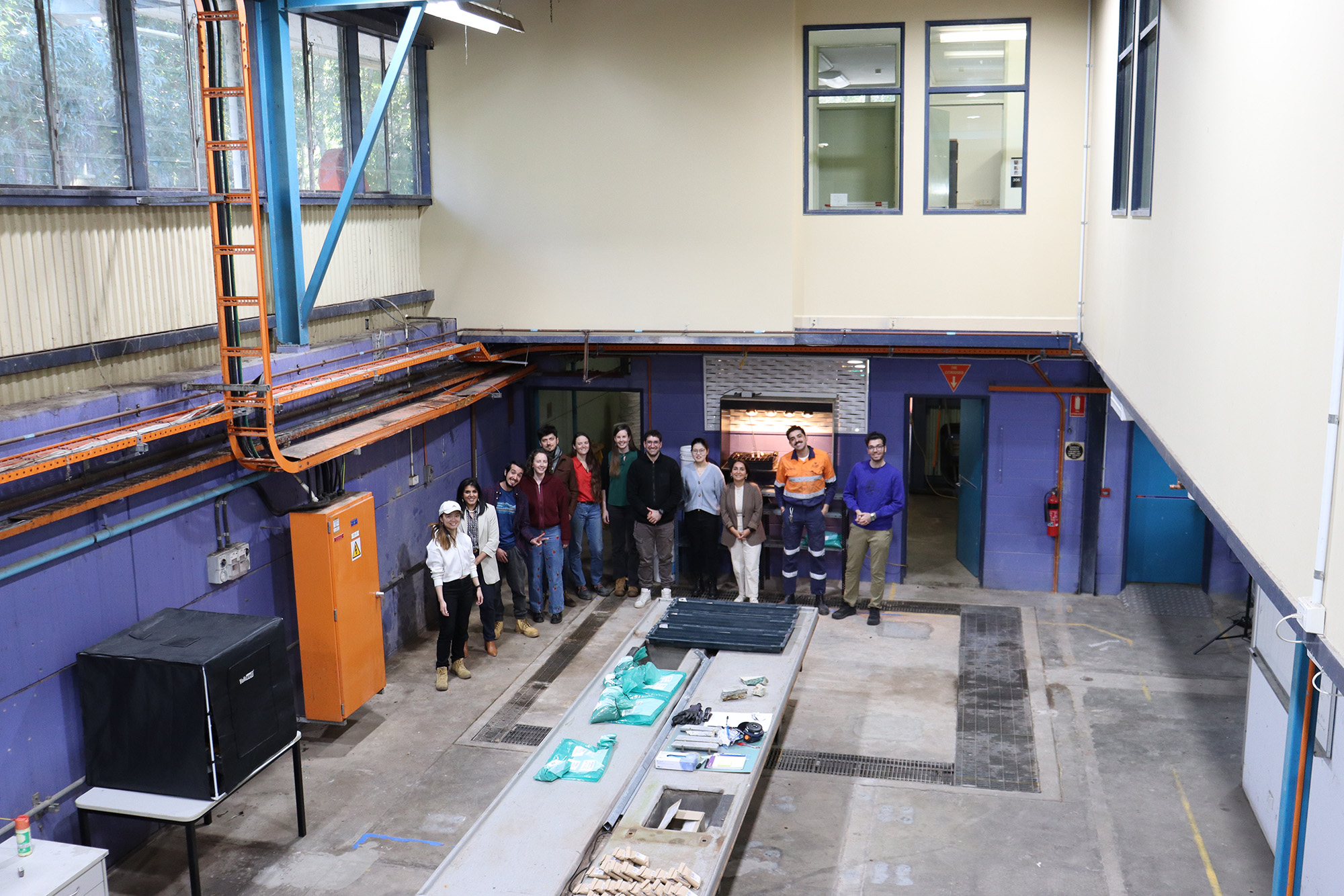 Long shot image of MIWATCH team standing gin new space