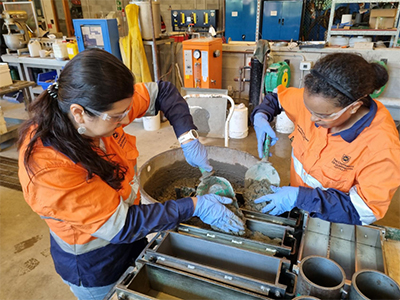 Researchers testing materials in a UQ Workshop