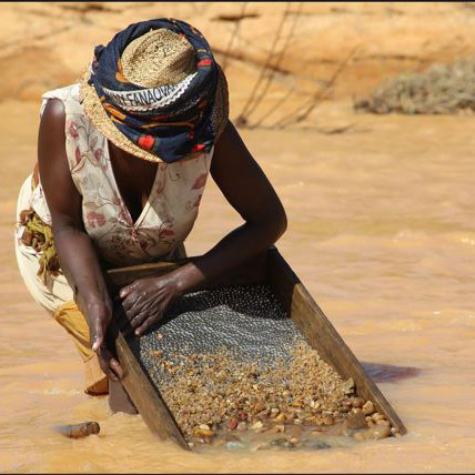 Woman panning for gems and minerals in Africa