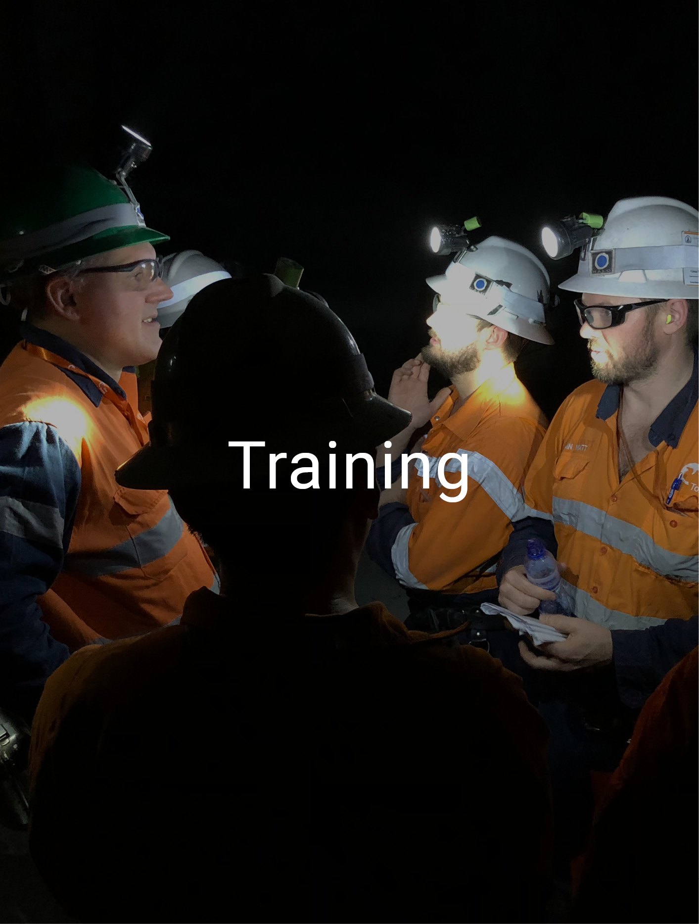 text 'Training' over background of workers in PPE