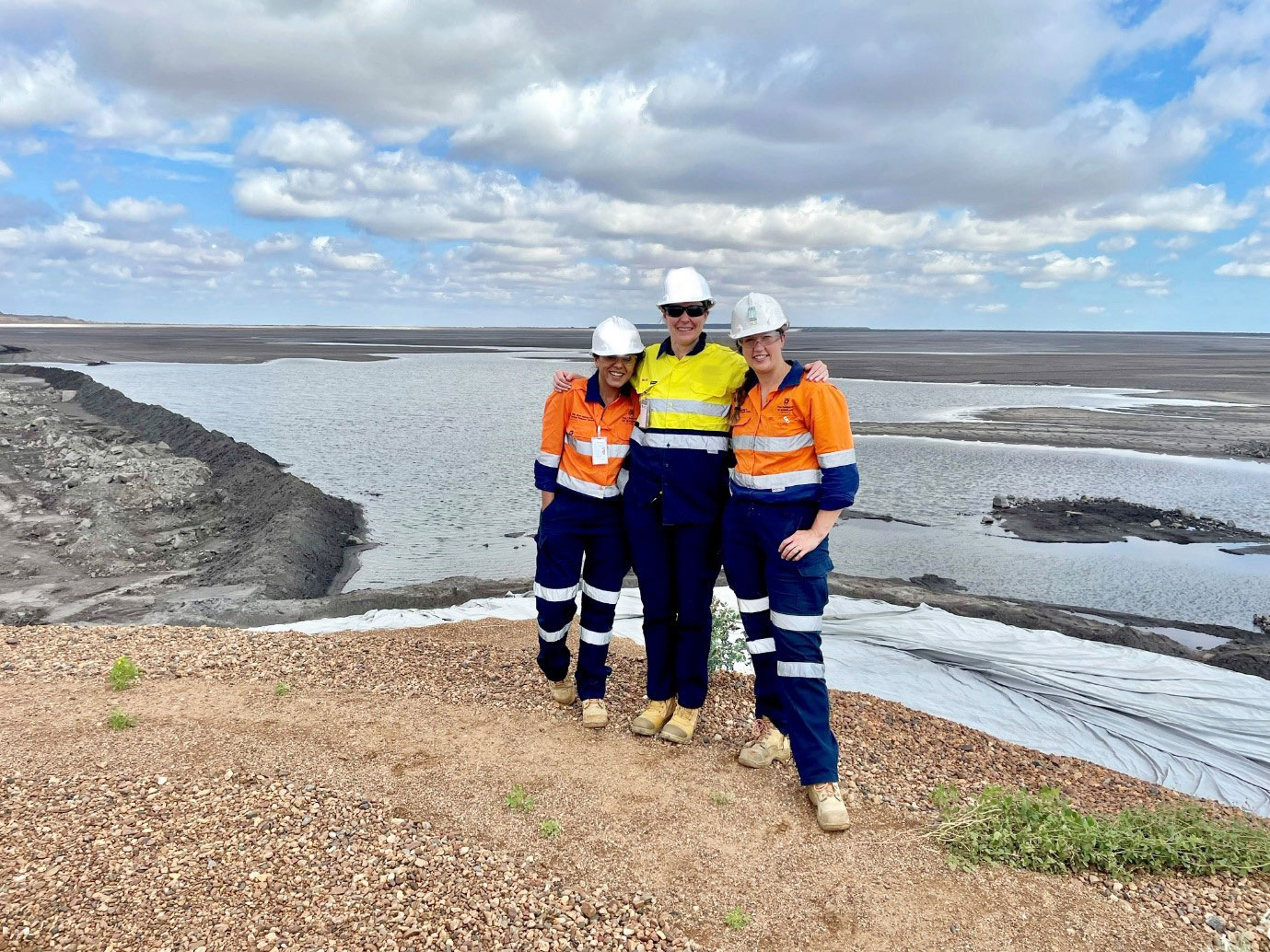  Anita Parbhakar-Fox, Helen Degeling and Laura Jackson posing atop a hill with Queensland Rocklands in the background