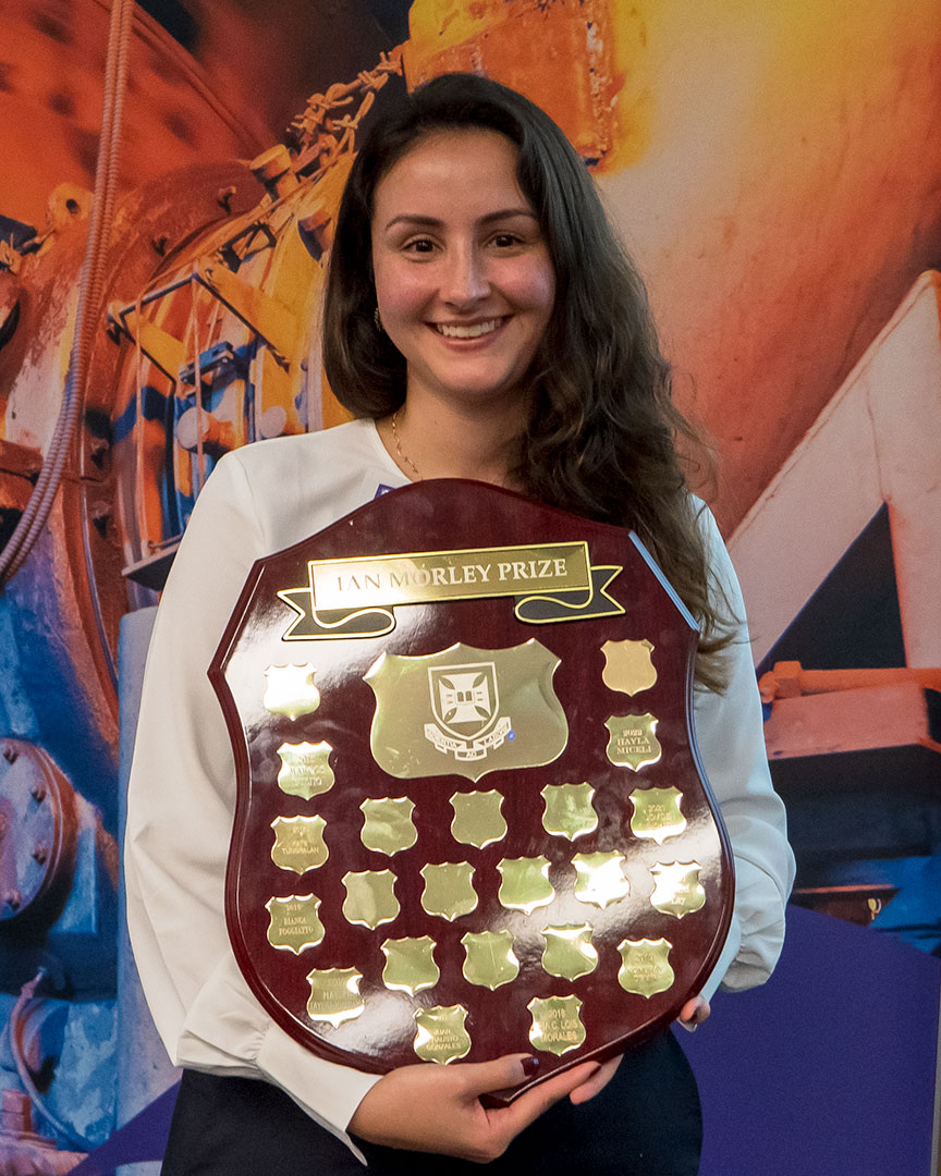 Hayla Miceli holding up Ian Morley Prize award plaque