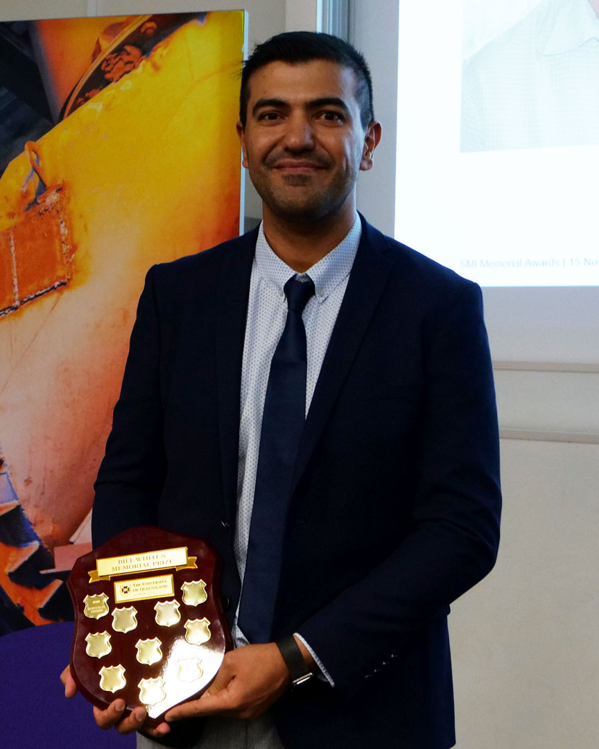 Konuray Demir holding the Bill Whiten award plaque