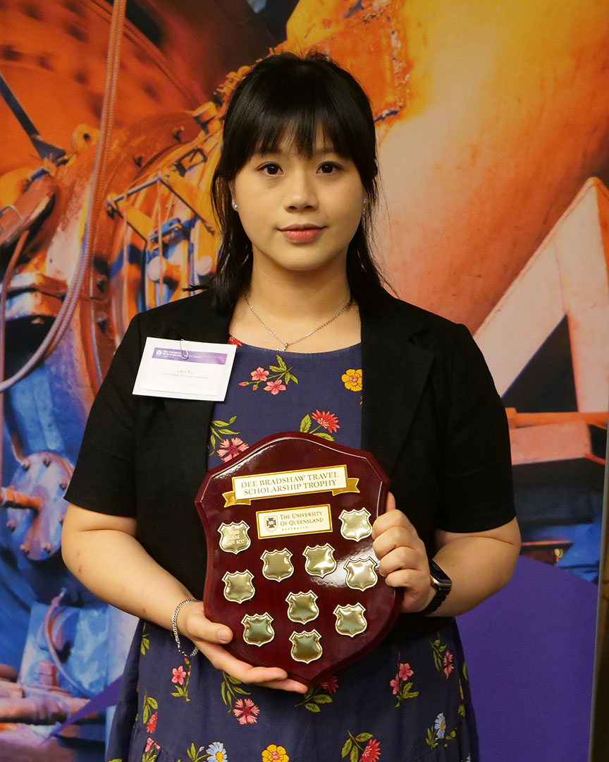 Lam Ian Ku holding the Dee Bradshaw Travel Scholarship award plaque