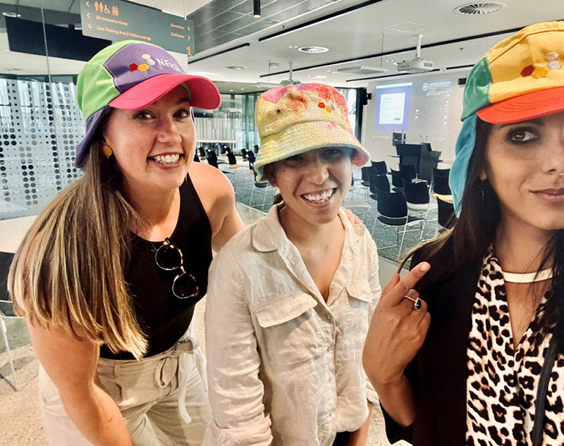  Laura Jackson, Kam Bhowany, Anita Parbhakar-Fox wearing colourful SS22/23 NExUS hats