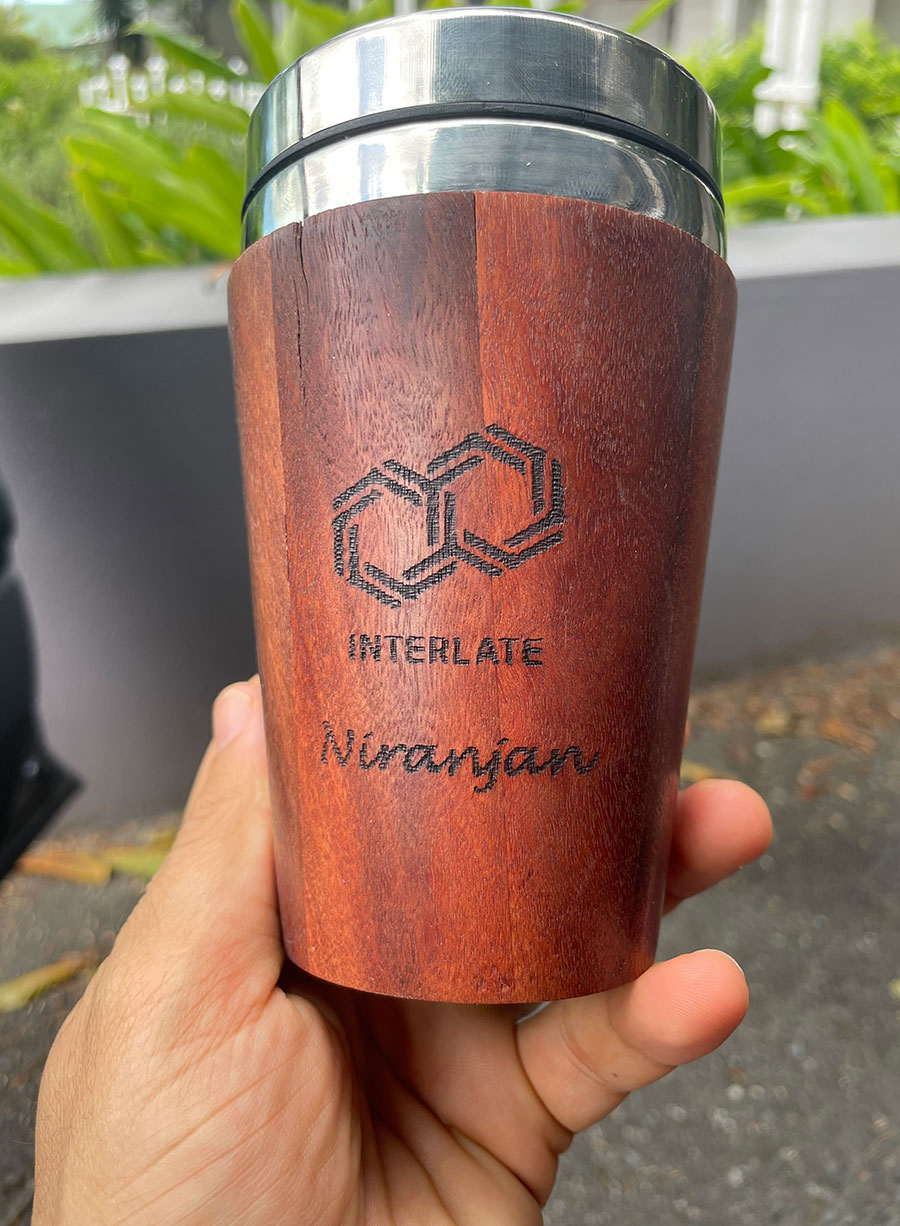 Niranjan Adhikari holding up an Interlate reusable cup