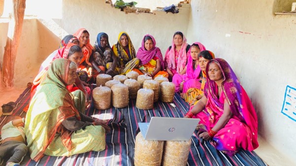 women from the Panna District, India, gathering around laptop