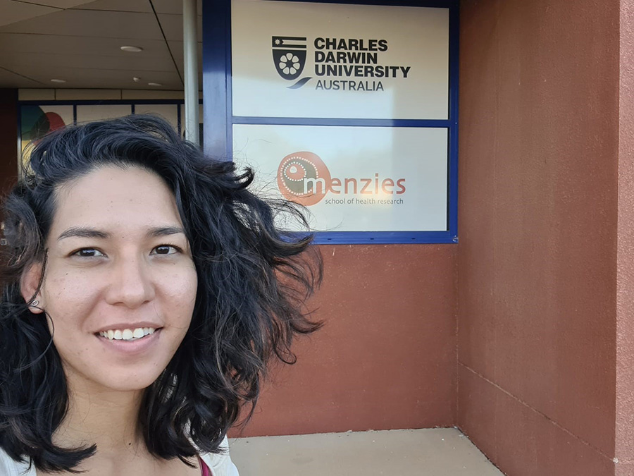 Kam Bhowany in front of the Charles Darwin University, Australia sign