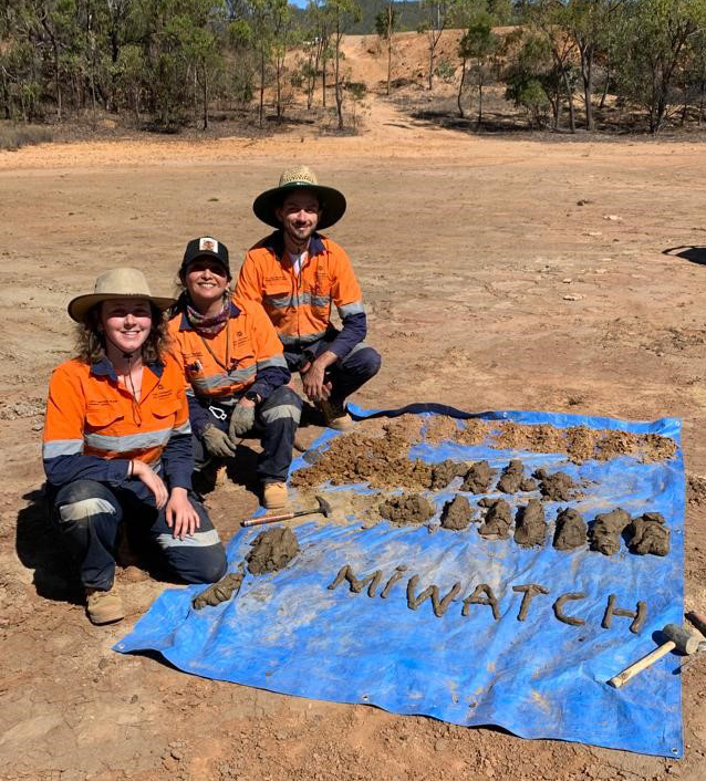 Rosie Blannin, Allan Silva Gomes and Olivia Mejías next to samples of tailings