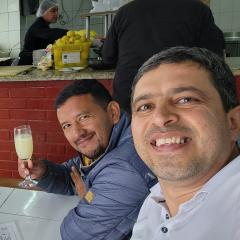 Mohsen Yahyaei at food and drink venue toasting with new friends in Santiago