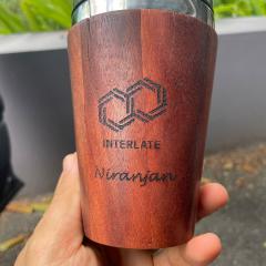 Niranjan Adhikari holding up an Interlate reusable cup