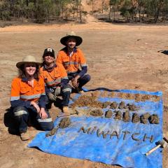 Rosie Blannin, Allan Silva Gomes and Olivia Mejías next to samples of tailings