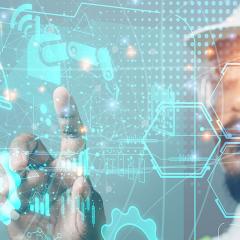 Person wearing hard had and safety glasses interacting with holographic data