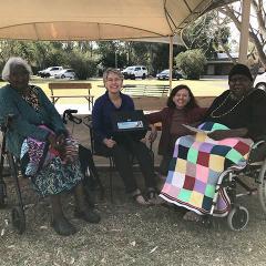 Sarah and Hannah Corbett from the CLC (centre) with Mavis Nampitjinpa and Barbara Marks at Old Timers