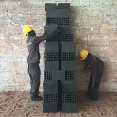 Workers stack clay bricks in a kiln in preparation for firing, Mozambique, credit: Daniel Franks