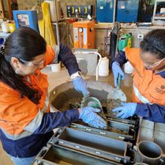 Researchers testing materials in a UQ workshop