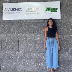 Sibele Nascimento standing in front of The University of Queensland's Sustainable Minerals Institute, Experimental Mine Site